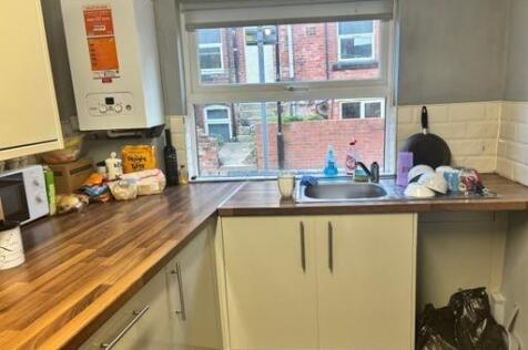 A functional student kitchen with natural light...