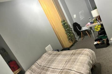 A compact bathroom featuring a toilet, with som...