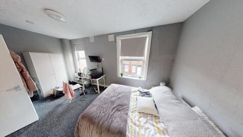 A cozy and well-maintained bedroom with a comfo...