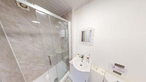 Bright and clean bathroom featuring a spacious ...