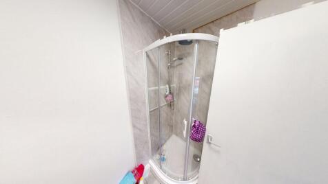 A clean and functional bathroom featuring a gla...