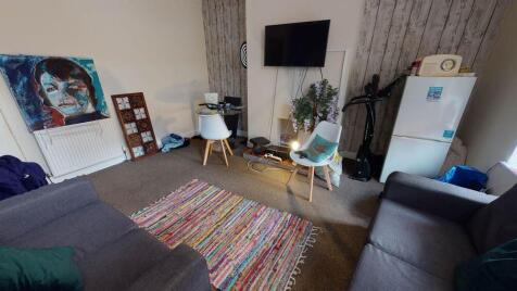 A contemporary living room featuring a large so...