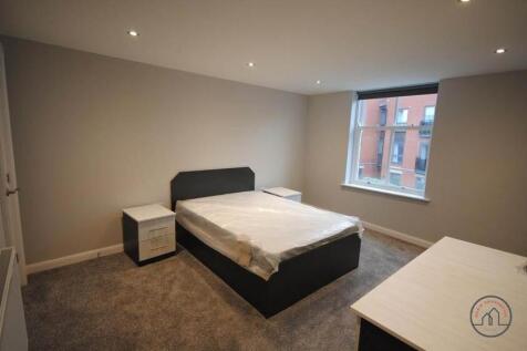 A spacious, modern bedroom featuring a double b...