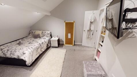 A well-maintained bedroom with a double bed and...