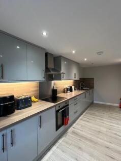 A modern, well-maintained kitchen with sleek ca...