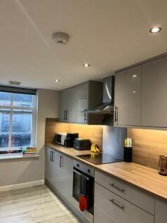 Modern and well-equipped kitchen featuring slee...