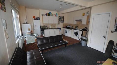 A modern, well-lit living room featuring a comf...