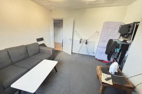 A spacious and comfortable living room featurin...