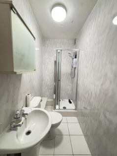 A clean and bright bathroom featuring a white s...