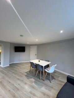 Bright and modern living room featuring a mount...