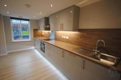 A modern, well-lit kitchen with ample counter s...