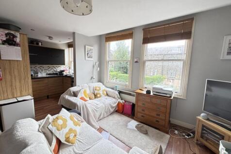 A bright and inviting living room featuring lar...