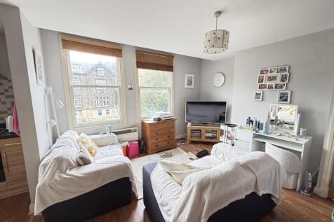 A modern, bright living room featuring large wi...