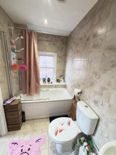 A clean, well-maintained bathroom with bright l...