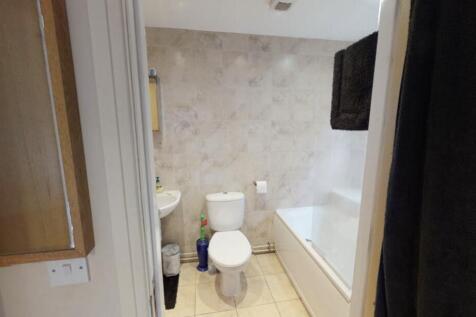 A clean and functional bathroom with a toilet, ...