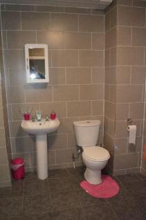 A clean, modern bathroom featuring a white toil...