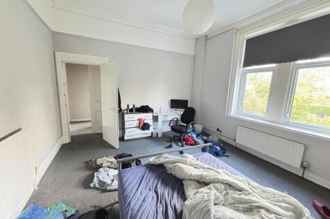 A contemporary living room with large windows a...