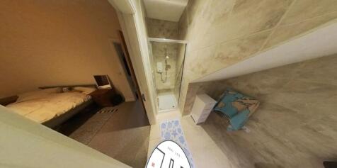 A spacious and modern bathroom with a large bat...