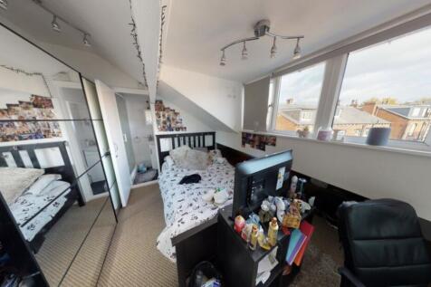 Bright and spacious living room with large wind...