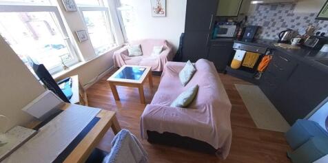 A bright and welcoming living room featuring a ...