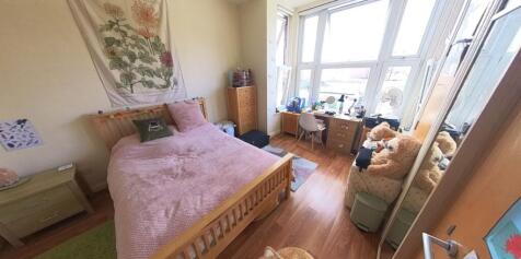 A bright and inviting bedroom featuring a doubl...