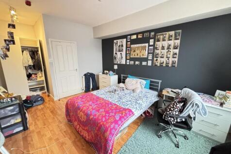 Bright and spacious master bedroom with a large...