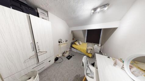 A tidy bedroom with a modern aesthetic, featuri...