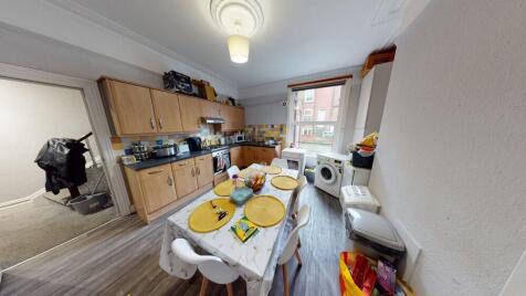 A bright and functional kitchen with ample stor...