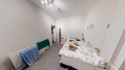 A well-maintained bedroom featuring a double be...