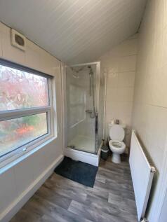 A clean and functional bathroom with a shower e...