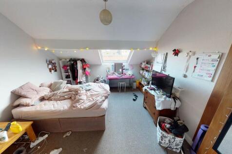 A cozy, well-lit living room with a large windo...