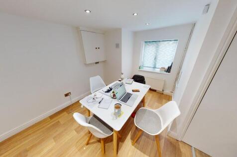 Bright and modern living room featuring ample n...