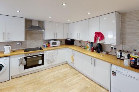 Bright and modern kitchen with ample cabinetry ...
