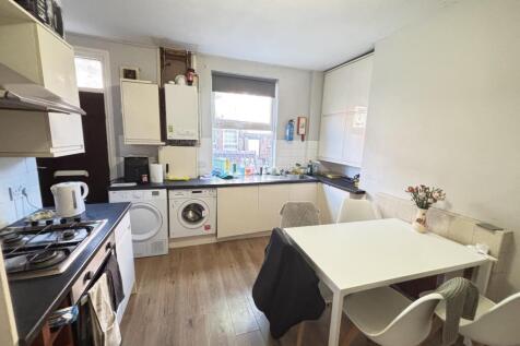 A bright, modern living room featuring a cozy a...