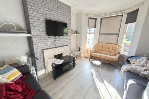 A bright and spacious living room featuring lar...