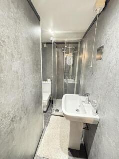 A clean and modern bathroom featuring a compact...