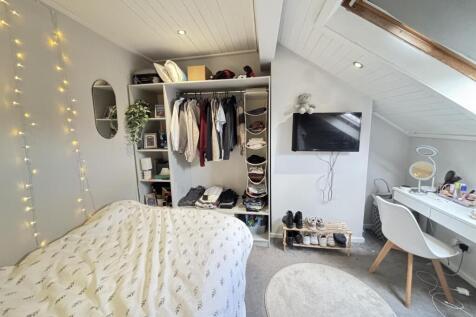 A bright and inviting master bedroom featuring ...