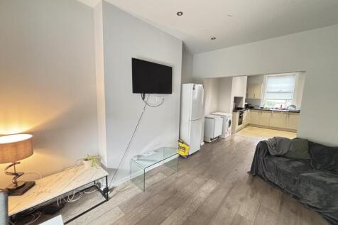 A spacious and well-lit contemporary living roo...