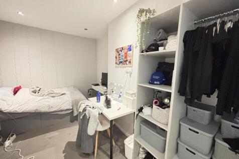 A bright and neatly maintained bedroom with a c...