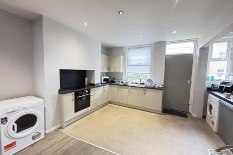 A bright and modern kitchen with ample natural ...