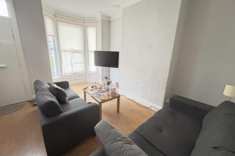 A bright and welcoming living room featuring tw...