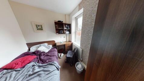 A cozy bedroom with natural light coming throug...