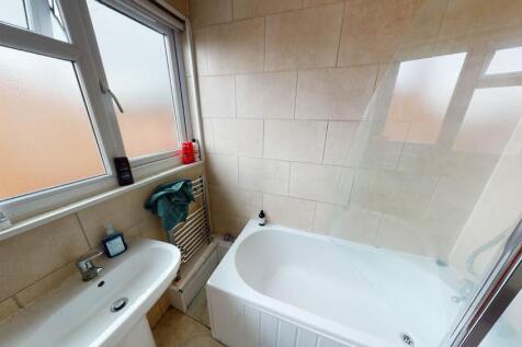 Bright and clean bathroom featuring a spacious ...
