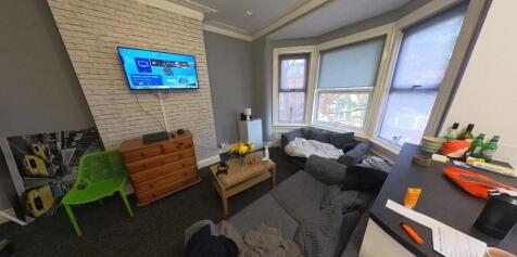 A bright and spacious living room with ample na...