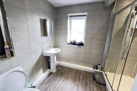 A modern, clean bathroom with ample natural lig...