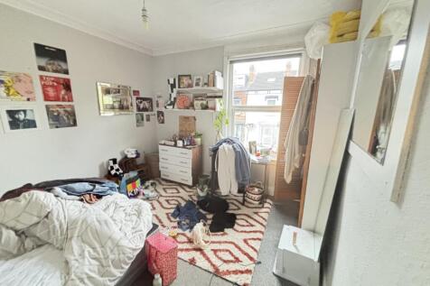 A bright and welcoming living room featuring na...