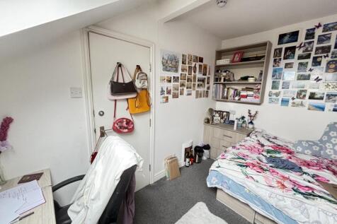 A cozy and inviting bedroom featuring a bed wit...