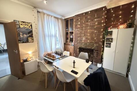 A modern, well-lit living room featuring a cozy...