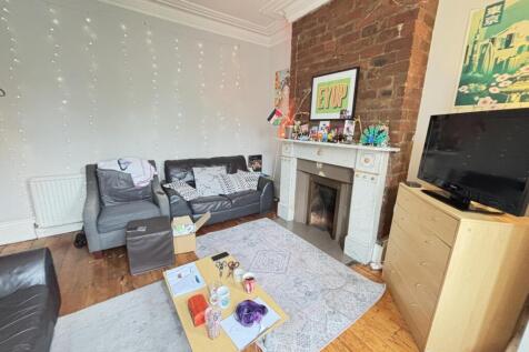 A well-lit, comfortable living room with modern...