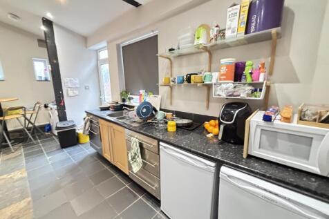 A modern and well-organized kitchen with ample ...